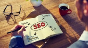 Hipster Writing Seo Concepts On His Note